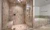 Stunning master bathroom with a glass and tile shower.